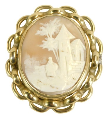 A late 19thC shell cameo brooch, depicting maiden with outbuildings, in a pleated silver plated frame, 4cm x 6cm, with swivel centre, 40g all in.