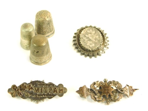 Three Victorian bar brooches, comprising a Mizpah brooch, 4.5cm wide, a bar brooch with central star detail, 5cm wide, and an oval floral brooch, lacking back, 4cm wide, together with three various silver thimbles, 189.6g all in.