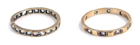 Two eternity rings, comprising a diamond set and break design eternity ring, yellow metal stamped 9ct, size Q½, and a full eternity ring, set with CZ stones, on a yellow metal band, unmarked, size P½, 3.5g all in. (2)