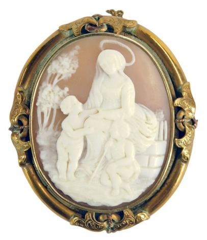 A 19thC shell cameo brooch, the central cameo depicting maiden with halo and two children, with trees, in a brass floral surround, on single pin back with safety chain, 28.2g all in, 5cm x 6cm.