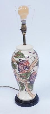 A Moorcroft table lamp, on a cream ground with pink and purple flowers, on ebonised base, with cream shade, 54cm high. - 2