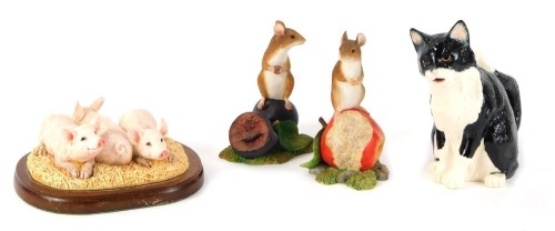 A Border Fine Arts Studio mouse on a plum A8008, 10cm high, a Border Fine Arts Studio mouse on an apple A8003, 11cm high, Border Fine Arts Three Little Piglets figure group A27072, 13cm wide, and a James Herriott Country Kitchen Collection Cat jug A7118,