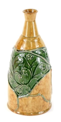 An early 20thC glazed stoneware bottle, on a brown ground with green floral panels in the Art Nouveau style, unmarked, 27cm high.
