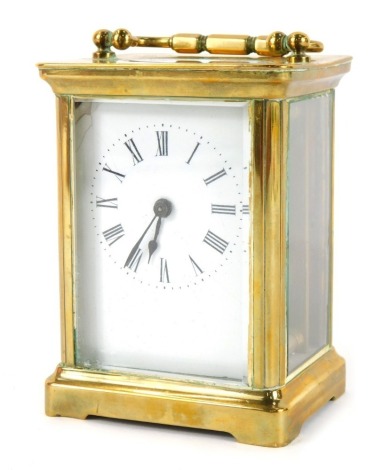 A 20thC brass carriage clock, of rectangular form, with a white enamel Roman numeric dial, in a brass case with open work movement, 10.5cm high, 5.5cm wide, 5.5cm deep.