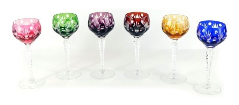 A set of six coloured hock glasses, each with a five point star and circle design, on faceted stems, comprising green, pink, red, yellow, blue, and purple, 20.5cm high.