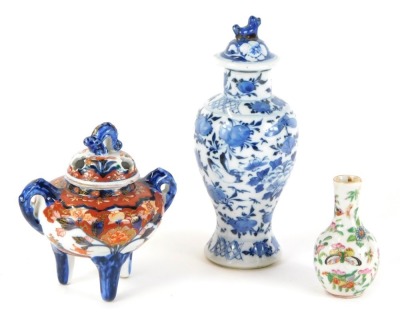 A group of Oriental ceramics, comprising a blue and white vase and cover, the lid with dog of fo, with four character stamp to underside, 21cm high, an Imari porcelain censer with lid, 13cm high, and a miniature Canton famille rose vase, 9cm high. (3)