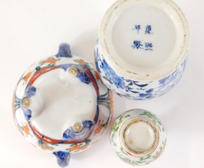 A group of Oriental ceramics, comprising a blue and white vase and cover, the lid with dog of fo, with four character stamp to underside, 21cm high, an Imari porcelain censer with lid, 13cm high, and a miniature Canton famille rose vase, 9cm high. (3) - 2