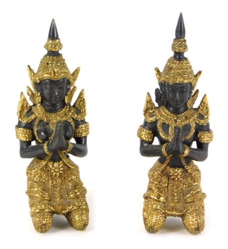 A pair of Thai bronze and gilt figures, each of a praying goddess, with elaborate gilt dress, 12cm high. (2)