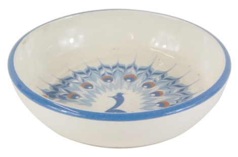 A Humphrey Wakefield Isle of Scilly pin dish, with peacock design on blue border, 10cm diameter.