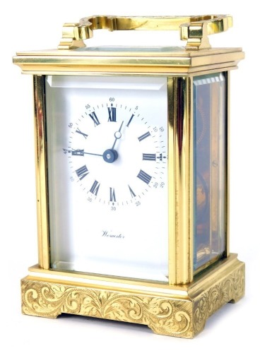 A 20thC brass carriage clock, with white Roman numeric dial, with key wind marked Worcester, with openwork movement, and scroll design case with swing handle, 11cm high.