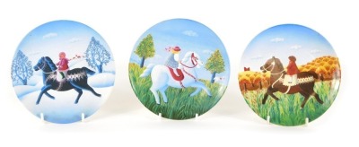 Three Poole pottery plates, each depicting figures on horseback, 15.5cm diameter.