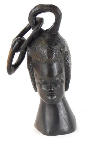 Tribal Art. A carved figure of a female head, with two chain link top, 19cm high.