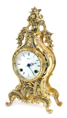 A Mozer brass mantel clock, enamel dial, eight day movement, with a floral swag top, of rococo scroll out splayed feet, 33cm high.