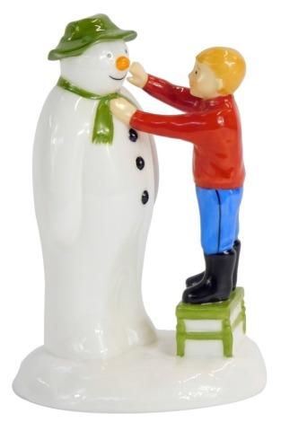 A Coalport Characters The Snowman figure, Adding a Smile, 14cm high, boxed.