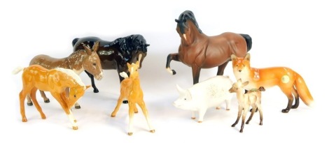 A group of Beswick animal ornaments, comprising a matt rearing horse, two palomino horses, a fox, large donkey, large pig and a brown mare. (7)