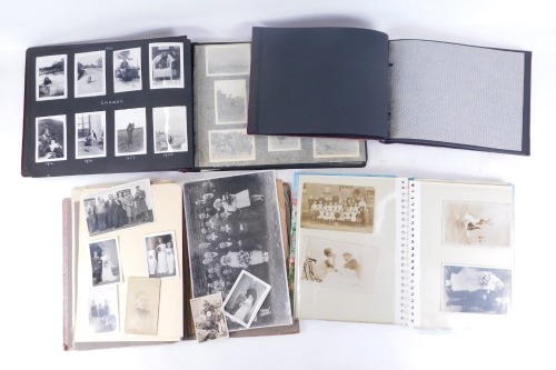 Postcards and photographs, comprising three various postcard albums, each with black and white full profile pictures, various photographic prints, loose pieces, etc. (1 box)