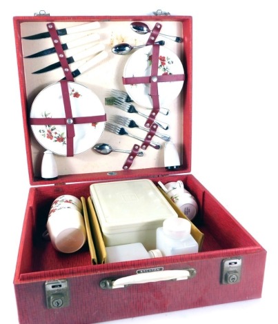 A Brexton picnic hamper, with red and white floral pattern, cased cutlery and Tupperware, in a fitted case, 14cm high, 41cm wide, 38cm deep.