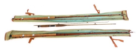 Two split cane fishing rods, in canvas bags.