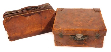 A canvas bound trunk and a leather gladstone bag. (2, AF)