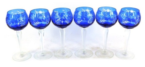 A set of six blue glass hoch glasses, each with a vine and star detail, raised on a faceted stem, 18cm high.