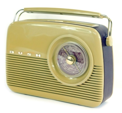 A Bush vintage radio, with a brown Bakelite case, in purple faux leather banding, 27cm high.