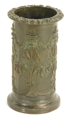 A 19thC bronze spill vase, of cylindrical form, with a fluted floral top, embossed with floral swags and acanthus leaves, stamped A & P, 12cm high.