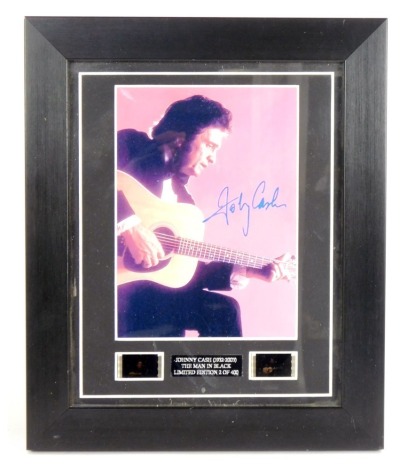 Johnny Cash (1932-2003). The Man in Black, photograph with printed signature, limited edition 2/400, with certificate of authenticity for The Heritage Arts & Culture Ltd, in a black frame, 32cm x 26cm.