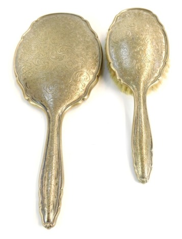 A dressing table set, with engraved floral and foliate backs, white metal stamped 835, comprising hand mirror and hair brush.