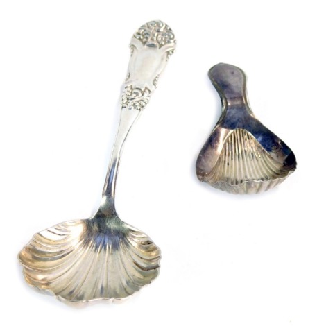 A George III silver caddy spoon, with fluted bowl, Sheffield 1792, and a Victorian silver jam spoon with embossed floral terminal, Birmingham 1890, 1oz gross. (2)