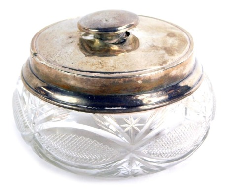 A silver and cut glass dressing table jar, the circular top of plain design with knop handle, on etched cut glass bowl. (AF)