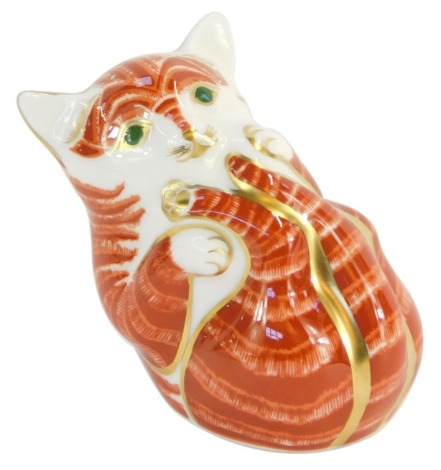 A Royal Crown Derby cat paperweight, of a ginger cat playing, with gold 21 Year stopper.