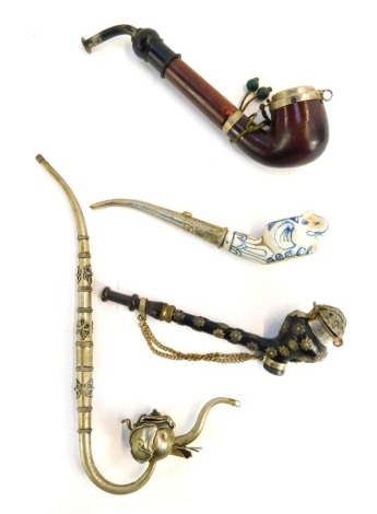 Four pipes, comprising an Eastern opium pipe, carved hardwood pipe, star set pipe and blue and white elephant pipe. (4)