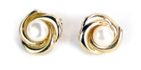 A pair of cultured pearl earrings, in a triple scroll yellow metal mount, pin stamped 375, 1.0g all in.