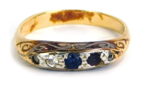 An 18ct sapphire and diamond dress ring, set with illusion set sapphires and diamonds, in white gold, on a yellow metal band, size L, 3.3g all in.