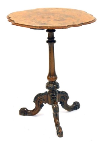 A Victorian walnut table, with a shaped top, inlaid with flowers, on a carved tripod base, 72cm high, the top 54cm x 44cm.