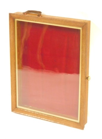 A light wood table top display cabinet, with a red lined interior, 37cm x 47cm, 7cm high.