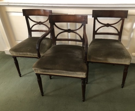 Three George III mahogany dining chairs, comprising two dining chairs and one carver, each having ebony inlaid overrun cresting rails, X frame backs, reeded uprights and turned legs. (3)