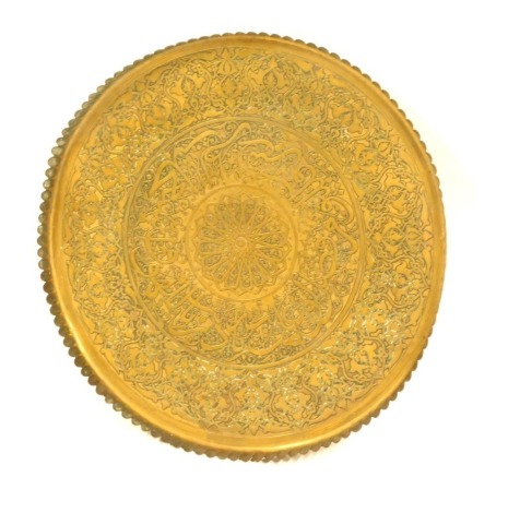 An Eastern hammered brass serving tray, 63cm diameter.