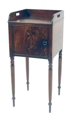 A 19thC mahogany bedside cabinet, with raised galleried top, above cupboard door, with slatted interior, on tapered legs, 82cm high, 37cm wide, 36cm deep.