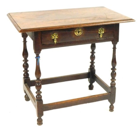 An 18thC oak side table, the top with a moulded edge above a drawer on turned supports, 71cm high, 81cm wide.