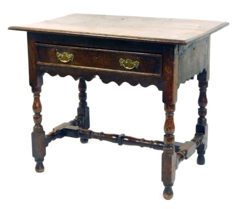 An early 19thC oak hall table, with a rectangular top, above two drawers, on H framed base, 72cm high, 86cm wide, 57cm deep.