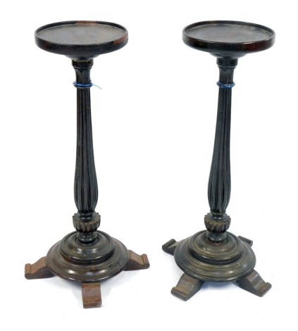 A pair of mahogany plant stands, circular foot on a reeded and bulbous column, with four outsplayed legs, 89cm high, 28cm diameter.