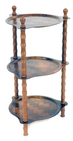 A three tier whatnot, each shelf formed as a circular plate, with rectangular cross hatched detail, on bobbin turned supports, 77cm high.