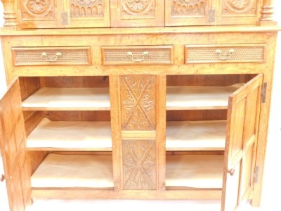 An oak court cupboard, in the 17thC style, carved overall with roundels, leaves and scrolls with unusual carved drawers, on stiles, 182cm high, 166cm wide. - 2