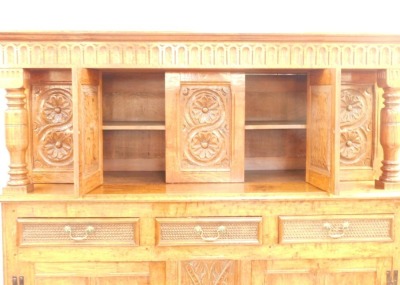 An oak court cupboard, in the 17thC style, carved overall with roundels, leaves and scrolls with unusual carved drawers, on stiles, 182cm high, 166cm wide. - 3