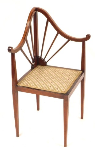 An Edwardian walnut corner chair, with a moulded sun burst back, with a tapestry seat, 86cm high.