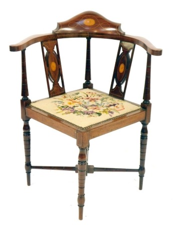 An Edwardian mahogany corner chair, with inlaid back, and shaped arms, on X frame base, with tapestry floral seat, 84cm high.