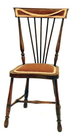 An Edwardian nursing chair, with a pink upholstered seat and fan shaped back, 80cm high.