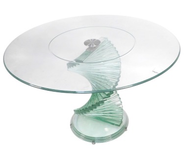 A modern circular glass dining table, on twisted stepped base, 74cm high, 120cm diameter. (AF)