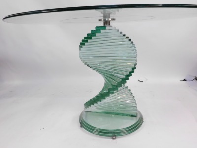 A modern circular glass dining table, on twisted stepped base, 74cm high, 120cm diameter. (AF) - 2